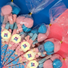 Sweet cones for neutral baby showers with a variety of blue and pink sweets. Sticker on front says "boy or girl?"